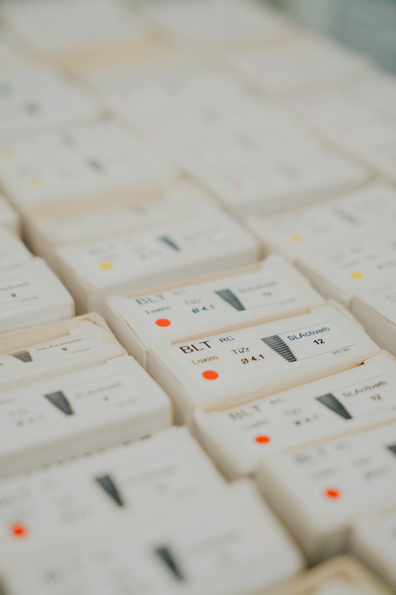 Detailed view of dental micro implant screws organized symmetrically for medical or dental use.